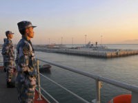 Chinese naval soldiers stand guard on China's first aircraft carrier Liaoning, as it travels towards a military base in Sanya, Hainan province, in this undated picture made available on November 30, 2013. REUTERS/Stringer Chinese naval soldiers stand guard on China's first aircraft carrier Liaoning, as it travels towards a military base in Sanya, Hainan province, in this undated picture made available on November 30, 2013. REUTERS/STRINGER