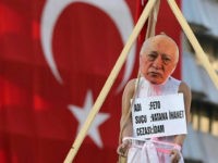 A picture taken on August 2, 2016 shows a picture of US-based preacher Fethullah Gulen set up on a dummy at the Kizilay Square in front of a Turkish national flag in Ankara during a protest against the failed military coup, on August 2, 2016. Erdogan said on August 2, 2016 last month's attempted coup was a scenario drawn up from outside Turkey, in an allusion to possible foreign involvement in the plot. Erdogan, who blames the plot on the US-based preacher Fethullah Gulen, also described the coup as a 'scenario written from outside' in an allusion to foreign involvement. / AFP / ADEM ALTAN (Photo credit should read ADEM ALTAN/AFP/Getty Images)