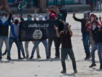 Kashmiri Muslim protesters hold a flag of Islamic State as they shout anti-India slogans during a protest in Srinagar, Indian controlled Kashmir, Friday, April 8, 2016. Police fired teargas and pellet guns to disperse Kashmiris who gathered after Friday afternoon prayers to protest against Indian control over a part of the disputed region of Kashmir. (AP Photo/Dar Yasin)