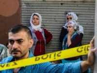 People stand near the explosion scene following a late night attack on a wedding party that left at least 30 dead in Gaziantep in southeastern Turkey near the Syrian border on August 21, 2016. Turkish President Recep Tayyip Erdogan on Sunday said the Islamic State (IS) group was the 'likely perpetrator' of the bomb attack.