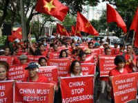 Filipino and Vietnamese protesters display anti-China placards and Vietnamese national flags during a call on China to respect their rights in the disputed South China Sea, in front of the Chinese consular office in Manila on August 6, 2016. The Philippines told its fishermen on August 3 to steer clear of a fishing ground in the disputed South China Sea to avoid harassment from Chinese authorities. The warning came despite a recent ruling by a UN-backed tribunal in favour of the Philippines, as it dismissed China's territorial claims to large swathes of the waters. Vietnam, Malaysia, Brunei and Taiwan also have claims to the sea, through which over 5 trillion USD in annual trade passes. / AFP / TED ALJIBE (Photo credit should read TED ALJIBE/AFP/Getty Images)