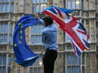 A man waves a British flag and a European flag at an anti-Brexit protest in central London on June 28, 2016
