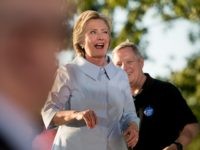 Democratic presidential candidate Hillary Clinton, accompanied by Sen. Dick Durbin, D-Ill., right, winks as she finishes speaking at the annual Salute to Labor at Illiniwek Park Riverfront in Hampton, Ill., Monday, Sept. 5, 2016. (AP Photo/Andrew Harnik)