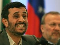 Iranian President Mahmoud Ahmadinejad (L) gestures as Iranian Foreign Minister Monouchehr Mottaki listens during a press conference at the end of the OPEC summit in Riyadh, 18 November 2007. Ahmadinejad said that Iran never wanted to use oil as a weapon, but if the US attacked the country it would 'know how to react.' AFP PHOTO/HASSAN AMMAR (Photo credit should read HASSAN AMMAR/AFP/Getty Images)