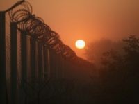 The sun rises over the nearly completed border fence at the Hungarian border with Serbia on September 13, 2015 in Roszke, Hungary.