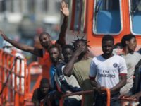 A group of immigrants wave as they arrive on a Spanish coast guard vessel into the southern Spanish port of Malaga on August 31, 2016 after an inflatable boat carrying 52 Africans, nine of them women, was rescued by the Spanish coast guard off the Spanish coast. / AFP / JORGE GUERRERO (Photo credit should read JORGE GUERRERO/AFP/Getty Images)