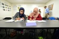 Syrian refugees take notes during their Vocational ESL class at the International Rescue Committee center in San Diego on August 31, 2016. Seated from left to right are: Rawa Hawara and Sousan Alziat.
The United States has taken in10,000 Syrian refugees in 2016 as part of a resettlement program that has emerged as a hot-button issue in the US presidential campaign. / AFP / Frederic J. BROWN        (Photo credit should read FREDERIC J. BROWN/AFP/Getty Images)