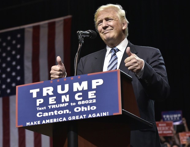Republican presidential nominee Donald Trump arrives on stage to speak at a rally at the Canton Memorial Civic Center on September 14, 2016 in Canton, Ohio. / AFP / MANDEL NGAN (Photo credit should read MANDEL NGAN/AFP/Getty Images)