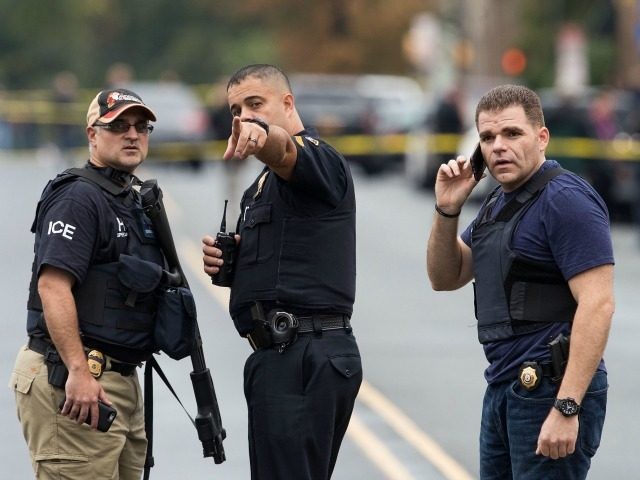 9: Law enforcement officials gather at the site where Ahmad Khan Rahami, who was wanted in connection to Saturday night's bombing in Manhattan, was arrested after a shootout with police, September 19, 2016 in Linden, New Jersey. On Monday morning, law enforcement released a photograph of 28-year-old Ahmad Khan Rahami, who they are seeking in connection to the attack. (Photo by