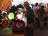TIJUANA, MEXICO - SEPTEMBER 24: Haitian refugees look over donated items at an immigrant center on September 24, 2016 in Tijuana, Mexico. In recent months a surge of Haitian refugees has arrived to Tijuana, seeking asylum at the border crossing into the United States. The center, called the Desayunador Salesiano Padre Chava, serves breakfast to more than 1,000 immigrants daily, many of them deportees from the United States. (Photo by John Moore/Getty Images)