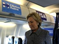 Democratic presidential nominee former Secretary of State Hillary Clinton returns to her cabin after speaking to reporters aboard her campaign plane at Chicago Midway Airport on September 29, 2016 in Chicago, Illinois.
