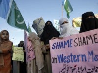 A girl holds a flag of Islamic political party Jamaat-e-Islami while taking part in a protest with others in Islamabad on May 20, 2010, against an online competition to draw pictures of Prophet Mohammad on Facebook which Muslims deem blasphemous. REUTERS/Faisal Mahmood