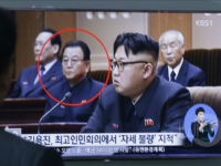 A man watches a TV screen showing a file image of Kim Yong Jin, second from left, a vice premier on education affairs in North Korea's cabinet, and North Korean leader Kim Jong Un, second from right, at the Seoul Railway Station in Seoul, South Korea, Wednesday, Aug. 31, 2016. North Korea has executed a vice premier and banished two other top officials to rural areas for re-education, South Korean officials said Wednesday. The letters read " North Korea has executed Kim Yong Jin". (AP Photo/Ahn Young-joon)