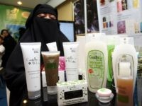 To go with feature story Lifestyle-Malaysia-cosmetics-Islam-halal by Beh Lih Yi This photo taken on 14 April, 2010 shows Muslimah Skincare and Cosmectics Managing Director Famiza Zulkifli (R) posing behind halal cosmetics during an interview with AFP at an exhibition centre in Kuala Lumpur. Entrepreneurs producing "halal" cosmetics say the global market is booming as more Muslims, as well as eco-conscious non-Muslims, opt for beauty products that conform to Islamic rules. AFP PHOTO (Photo credit should read AFP/AFP/Getty Images)