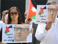 Protesters hold portraits of prominent Jordanian writer Nahed Hattar, who was shot dead the previous day outside an Amman court, during a demonstration in front of the prime minister's offices on September 26, 2016. Jordan's judiciary slapped a media blackout on the murder of the Christian writer who was gunned down outside a court where he faced charges over an anti-Islam cartoon. Hattar was hit by three bullets before the alleged assassin was arrested at the scene of Sunday's shooting in Amman's central Abdali district, official media said. / AFP / Khalil MAZRAAWI (Photo credit should read KHALIL MAZRAAWI/AFP/Getty Images)