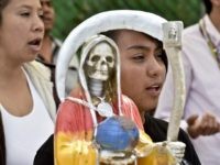 Devotees pray in front of a figure of the Santa Muerte (Holy Death) during a celebration at a sanctuary in Santa Maria Cuautepec, Tultitlan, Mexico on February 7, 2016. Narcos, gangsters and bad guys venerate the Santa Muerte, the Saint of death, probably a syncretism between Middle American and Catholic beliefs, although strongly condemned by the Catholic church as satanic.  AFP PHOTO / YURI CORTEZ / AFP / YURI CORTEZ        (Photo credit should read YURI CORTEZ/AFP/Getty Images)