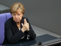 BERLIN, GERMANY - JULY 03: German Chancellor Angela Merkel attends a meeting of the Bundestag, Germany's federal parliament, about a vote on exceptions to the minimum wage law to take effect from next year on July 3, 2014 in Berlin, Germany. The country voted for a minimum wage of 8.50 euros (USD 11.60) an hour, to come into effect in 2015, with exceptions for vocational trainees, minors and certain interns, to be reviewed again two years after the new law takes effect. (Photo by Adam Berry/Getty Images)
