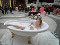 A model sits in a bathtub to promote a shopping mall in Hong Kong on February 5, 2009. A government spokesman said visitors to Hong Kong and solid spending by residents had helped boost retail figures, but warned it remained a tough environment. AFP PHOTO/MIKE CLARKE (Photo credit should read MIKE CLARKE/AFP/Getty Images)