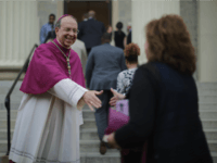 BALTIMORE, MD - APRIL 25: Catholic Archbishop of Baltimore William Lori (L) welcomes people to the Basilica of the National Shrine of the Assumption of the Blessed Virgin Mary for an interfaith prayer service for peace marking the first anniversary of unrest following the death of Freddie Gray April 25, 2016 in Baltimore, Maryland. The interfaith service comes in between the anniversary of Freddie Gray's death on April 19, 2015, and the riots following his funeral on April 27. (Photo by Chip Somodevilla/Getty Images)