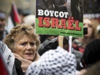 Demonstrators hold signs saying 'No Dutch support for apartheid in Palestine. Boycott Israel' during a protest in Amsterdam on November 17, 2012 against the Israeli air strikes on Palestinian targets in the Gaza Strip. AFP PHOTO / ANP / ERIK VAN ' T WOUD netherlands out (Photo credit should read ERIK VAN 'T WOUD/AFP/Getty Images)