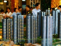 --FILE--Chinese homebuyers look at housing models at the sales center of a residential property project in Yichang city, central China's Hubei province, 4 June 2016. China's new home sales rose at the slowest pace so far this year amid policymakers' moves to cool the property market. New home sales climbed 32.9 percent to 773 billion yuan ($117 billion) in May from a year earlier, according to data the National Bureau of Statistics released Monday (13 June 2016). The increase compares with a 63.5 percent surge in April. Home sales fell 2.6 percent in May from April.(Imaginechina via AP Images)
