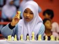 In this photogaph taken September 23, 2010, 15-year-old Diah Wardah Febrina makes her move against Indonesian rising chess star, 14-year-old national junior chess champion Masruri Rahman (not pictured), during simultaneous matches against 200 students at a Jakarta gymnasium in an exhibition game celebrating national sports day and promoting chess to youngsters. Masruri won the gold medal in the 13-year-old division at the 5th World School Chess Championship in Greece in 2009. The junior high school student comes from a poor family of six children, his father, who taugh him to play chess, earns a living as an autorickshaw driver while his mother accompanies him during his games. AFP PHOTO / ROMEO GACAD (Photo credit should read ROMEO GACAD/AFP/Getty Images)