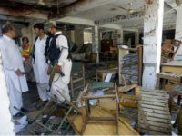Pakistani officials examine a site of a bombing in Mardan, Pakistan, Friday, Sept. 2, 2016. Northwestern Pakistan was struck by two separate militant attacks on Friday, when gunmen wearing suicide vests stormed a Christian colony near the town of Peshawar, killing one civilian, and a suicide bomb attack on a district court in the town of Mardan. (AP Photo/Mohammad Sajjad)
