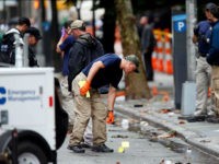 Evidence teams investigate at the scene of Saturday's explosion on West 23 Street in Manhattan's Chelsea neighborhood, Monday, Sept. 19, 2016, in New York. An Afghan immigrant wanted for questioning in the bombings that rocked a New York City neighborhood and a New Jersey shore town was captured Monday after being wounded in a gun battle with police. (AP Photo/Jason DeCrow)