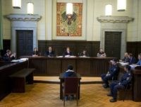 14-year-old Austrian schoolboy (C) with alleged ties to Islamist extremists accused of having intended to launch a bomb attack in Vienna in 2014 attends his trial on May 26, 2015, in St Poelten, Austria. AFP PHOTO / CHRISTIAN BRUNA (Photo credit should read CHRISTIAN BRUNA/AFP/Getty Images)