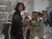SYRIA, ALEPPO : A Syrian civil defence member and a volunteer carry a little girl rescued from under the rubble of destroyed buildings following a reported airstrike on the rebel-held Salihin neighbourhood of the northern city of Aleppo, on September 10, 2016. The Syrian opposition on September 10 cautiously welcomed a ceasefire deal agreed by Moscow and Washington that could also see the first joint military campaign by the two powers against jihadists. / AFP PHOTO / THAER MOHAMMED