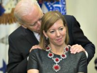 Biden nuzzles Def Sec wife AP