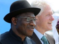 TO GO WITH AFP STORY BY BEN SIMON 
Nigerian President Goodluck Jonathan (L) and former US President Bill Clinton arrive on February 21, 2013 to attend the inauguration ceremony for the first phase of the Eko Atlantic real estate project, in Lagos, Nigeria. Eko Atlantic or Eko Atlantic City is a planned district of Lagos, Nigeria, being constructed on land reclaimed from the Atlantic Ocean. It will house some 250,000 people and be a workplace for another 150,000.   AFP PHOTO / PIUS UTOMI EKPEI        (Photo credit should read PIUS UTOMI EKPEI/AFP/Getty Images)