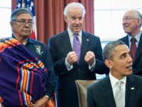 L-R: Samuel Gomez (L), War Chief of the Taos Pueblo, US Vice President Joseph R. Biden, US Secretary of the Interior Kenneth L. Salazar and Asha Lela, Chair of the Islanders for the San Juan Islands National Monument, look on as US President Barack Obama speaks about signing the First State National Monument in Delaware bill during a ceremony in the Oval Office of the White House March 25, 2013 in Washington, DC. Obama used the Antiquities Act to designate five new National Monuments. AFP PHOTO/Brendan SMIALOWSKI (Photo credit should read