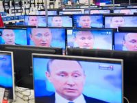 An employee stands by TV sets in a shop in Moscow on April 16, 2015 during the broadcast of Russian President Vladimir Putin's annual televised phone-in with the nation. AFP PHOTO / ALEXANDER UTKIN        (Photo credit should read ALEXANDER UTKIN/AFP/Getty Images)