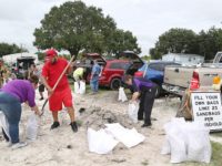 Locals scramble to fill sandbags with the last of a supply at the Road and Bridge Department in Kissimmee, Florida in preparation for the landfall of Hurricane Matthew, on October 6, 2016. 
Some three million people on the US southeast coast faced an urgent evacuation order Thursday as monstrous Hurricane Matthew -- now blamed for more than 100 deaths in Haiti alone -- bore down for a direct hit on Florida. / AFP / Gregg Newton        (Photo credit should read GREGG NEWTON/AFP/Getty Images)