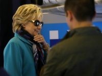 Democratic presidential nominee former Secretary of State Hillary Clinton talks with members of her staff aboard her campaign plane at Westchester County Airport on October 29, 2016 in White Plains, New York.