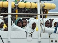 TOPSHOT - Men wait to disembark from the Italian Coast Guard vessel "Dattilo" following a rescue operation of migrants and refugees at sea, on February 1, 2016 in the port of Messina, Sicily. Over 10,000 unaccompanied migrant children have disappeared in Europe, the EU police agency Europol said yesterday, fearing many have been whisked into sex trafficking rings or the slave trade.  Europol's press office confirmed to AFP the figures published in British newspaper The Observer, adding that they covered the last 18-24 months.  AFP PHOTO / GIOVANNI ISOLINO / AFP / GIOVANNI ISOLINO        (Photo credit should read GIOVANNI ISOLINO/AFP/Getty Images)