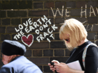 People walk past anti-fracking messages written on a wall during a demonstration outside Lancashire County Hall in Preston, northwest England, on June 23, 2015 against the applications from energy firm Cuadrilla to start two fracking operations on nearby sites. Lancashire County Council were expected to vote on June 24 on of one of two applications from energy firm Cuadrilla to start fracking operations at the nearby Little Plumpton and Roseacre Wood sites. Fracking or hydraulic fracturing is a process used to extract shale gas by blasting a high-pressure mixture of water, sand and chemicals deep underground to release hydrocarbons trapped between layers of rock. AFP PHOTO / PAUL ELLIS (Photo credit should read PAUL ELLIS/AFP/Getty Images)
