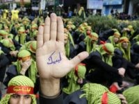A supporter of Lebanon's militant Shiite Muslim movement Hezbollah shows his hand reading in Arabic 'answering your call [Hussein]' during a parade as part of the Ashura commemorations that mark the killing of Imam Hussein -one of Shiite Islam's most revered figures- on November 4, 2014 in the capital Beirut's southern suburbs. The commemoration comes a day after Hezbollah chief Hassan Nasrallah made a rare appearance in the southern suburbs, calling on supporters to take part in Ashura despite 'any threat, any danger, any challenge'. AFP PHOTO / ANWAR AMRO (Photo credit should read ANWAR AMRO/AFP/Getty Images)