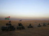 FILE -- In this Monday, Oct. 17, 2016 file photo, Peshmerga convoy drives towards a frontline in Khazer, about 30 kilometers (19 miles) east of Mosul, Iraq. In the week since Iraq launched an operation to retake Mosul from the Islamic State group, its forces have pushed toward the city from the north, east and south, battling the militants in a belt of mostly uninhabited towns and villages. In the heavily mined approaches to the city they met with fierce resistance, as IS unleashed suicide truck bombs, rockets and mortars. (AP Photo/Bram Janssen, File)