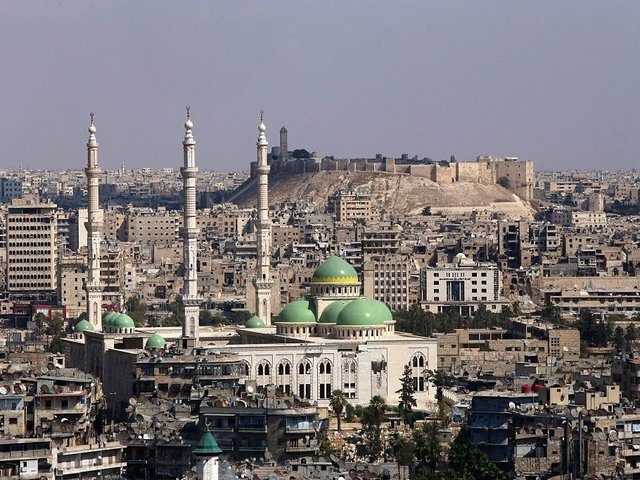 A general view taken on September 15, 2016, shows the UNESCO-listed citadel (C) in the government-controlled side of the divided northern Syrian city of Aleppo. Violence broke out in Aleppo in mid-2012, more than a year after anti-government protests first erupted across Syria. More than five years of war have turned Aleppo's historic city centre, a UNESCO-listed World Heritage site home to an imposing citadel, into a makeshift military barracks. / AFP / Youssef KARWASHAN (Photo credit should read YOUSSEF KARWASHAN/AFP/Getty Images)