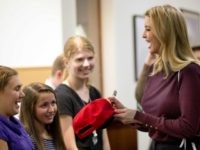 Ivanka Trump signs a hat during a campaign stop for her father, Republican presidential candidate Donald Trump, Thursday, Nov. 3, 2016, at the Founders Academy, a public chartered school in Manchester, N.H.