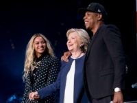 Democratic presidential candidate Hillary Clinton, center, appears on stage with artists Jay Z, right, and Beyonce, left, during a free concert at at the Wolstein Center in Cleveland, Friday, Nov. 4, 2016. (