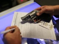 Mark O'Connor fills out his Federal background check paperwork as he purchases a handgun at the K&W Gunworks store on the day that U.S. President Barack Obama in Washington, DC announced his executive action on guns on January 5, 2016 in Delray Beach, Florida.
