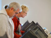 PROVO, UT - OCTOBER 25: People cast their ballots on electronic voting machines on the first day of early voting at the Provo Recreation Center, on October 25, 2016 in Provo, Utah. Early voting in the 2016 presidential election begins October 25 for Utah residents and is open until November 4. (Photo by George Frey/Getty Images)