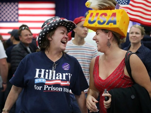 Cindy Hoffman (L) of Independence, Iowa, and Eric Smith of Cedar Rapids, Iowa, laugh together during a campaign rally for Republican presidential nominee Donald Trump at the W.L. Zorn Arena November 1, 2016 in Eau Claire, Wisconsin.