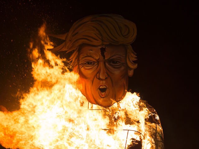Flames engulf an effigy of US presidential candidate Donald Trump as it is burned as the "Celebrity Guy" at the Edenbridge Bonfire Society bonfire night in Edenbridge, south of London, on November 5, 2016. The giant effigy of US presidential candidate Donald Trump wielding the head of rival Hillary Clinton went up in flames during the traditional British bonfire celebrations at Edenbridge south of London. The 36-foot (11-metre) high model of Trump dressed in shorts decorated with images of Mexicans was packed with fireworks and set alight as part of the annual Bonfire Night celebrations. / AFP / DANIEL LEAL-OLIVAS (Photo credit should read DANIEL LEAL-OLIVAS/AFP/Getty Images)