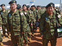 Members of the Japanese Ground Self-Defence Force (GSDF) arrive at the airport in Juba, South Sudan, on November 21, 2016.
A United Nations plane landed in the morning at Juba airport with 60 new Japanese peacekeepers as the first group of the 350-strong unit, which will replace the current Japanese troops at the UN mission in South Sudan. The group, mostly engineers, will construct roads and facilities and are also assigned for the first time under Japans new security law, which enables GSDF troops to use weapons to rescue UN staff under attack.  / AFP / SAMIR BOL        (Photo credit should read SAMIR BOL/AFP/Getty Images)