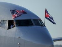 American Airlines plane fluttering US and Cuba national flags is seen uppon arrival at Jose Marti International Airport becoming the first Miami-Havana commercial flight in 50 years, coinciding with the beginning of the tributes to late Cuban leader Fidel Castro, on November 28, 2016 in Havana. / AFP / YAMIL LAGE (Photo credit should read
