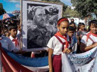 Children pay their last respects to Cuban revolutionary icon Fidel Castro in Bayamo, Granma province, on November 28, 2016. 
A titan of the 20th century who beat the odds to endure into the 21st, Castro died late Friday after surviving 11 US administrations and hundreds of assassination attempts. No cause of death was given. Castro's ashes will go on a four-day island-wide procession starting Wednesday before being buried in the southeastern city of Santiago de Cuba on December 4. / AFP / STR        (Photo credit should read STR/AFP/Getty Images)